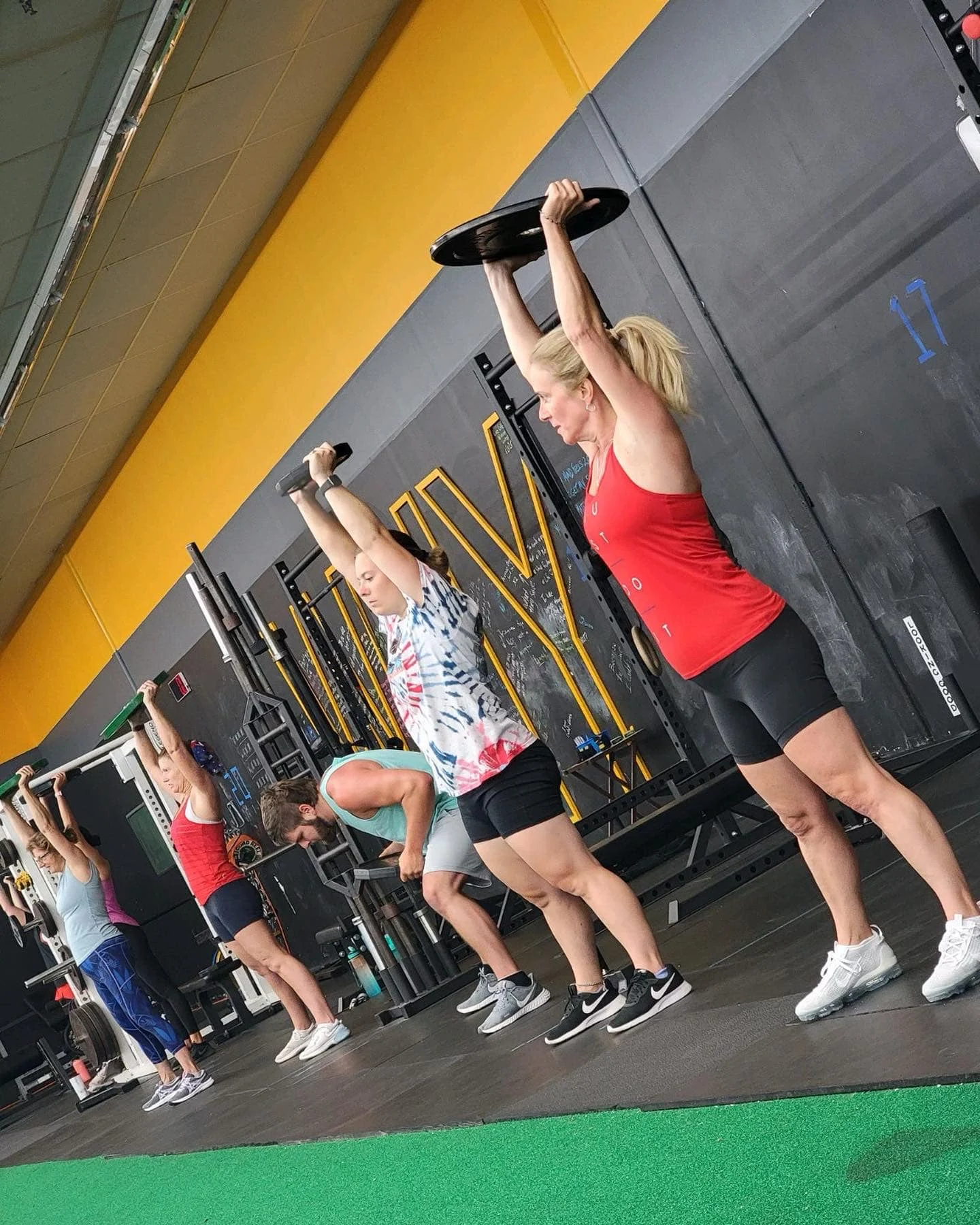 Member lifting dumbbells in the Synergy open gym